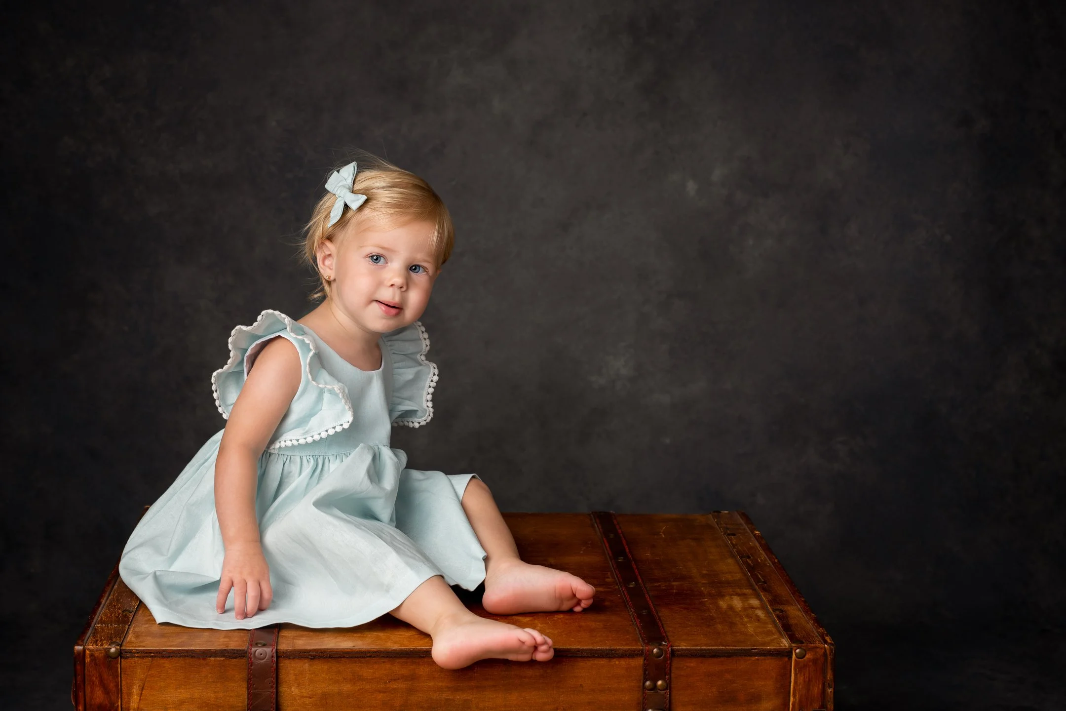  At a studio in NJ, Nicole Hawkins Photography captures a baby girl on a wooden chest. wooden chest photos toddler girl portraits NJ #nicolehawkinsphotography #NJstudioportraits #babyportraits #babygirlportraits #NJbabyphotographers #NJphotographers 
