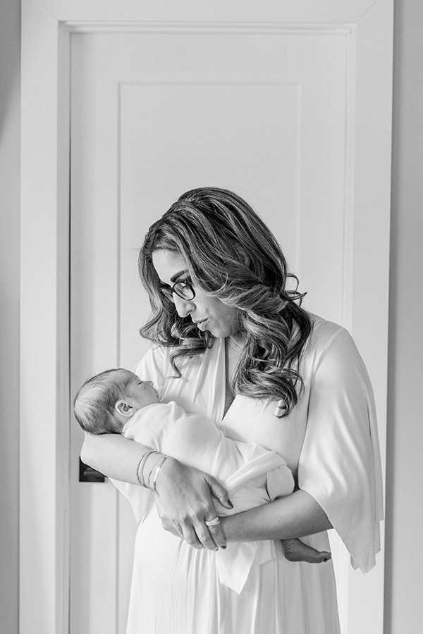  A new mother tends to her new baby during an at-home session with Nicole Hawkins Photography. motherhood portrait NJ newborns #nicolehawkinsphotography #NJfamilyphotographer #inhomenewbornsession #nicolehawkinsnewborns #NJnewbornphotography 