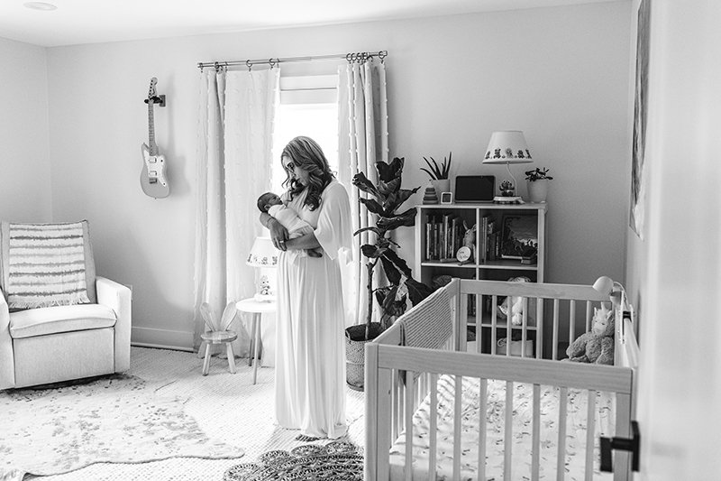  Nicole Hawkins Photography captures a mother in her nursery during an at-home session in New Jersey. New Jersey newborn photographers #nicolehawkinsphotography #NJfamilyphotographer #inhomenewbornsession #nicolehawkinsnewborns #NJnewbornphotography 