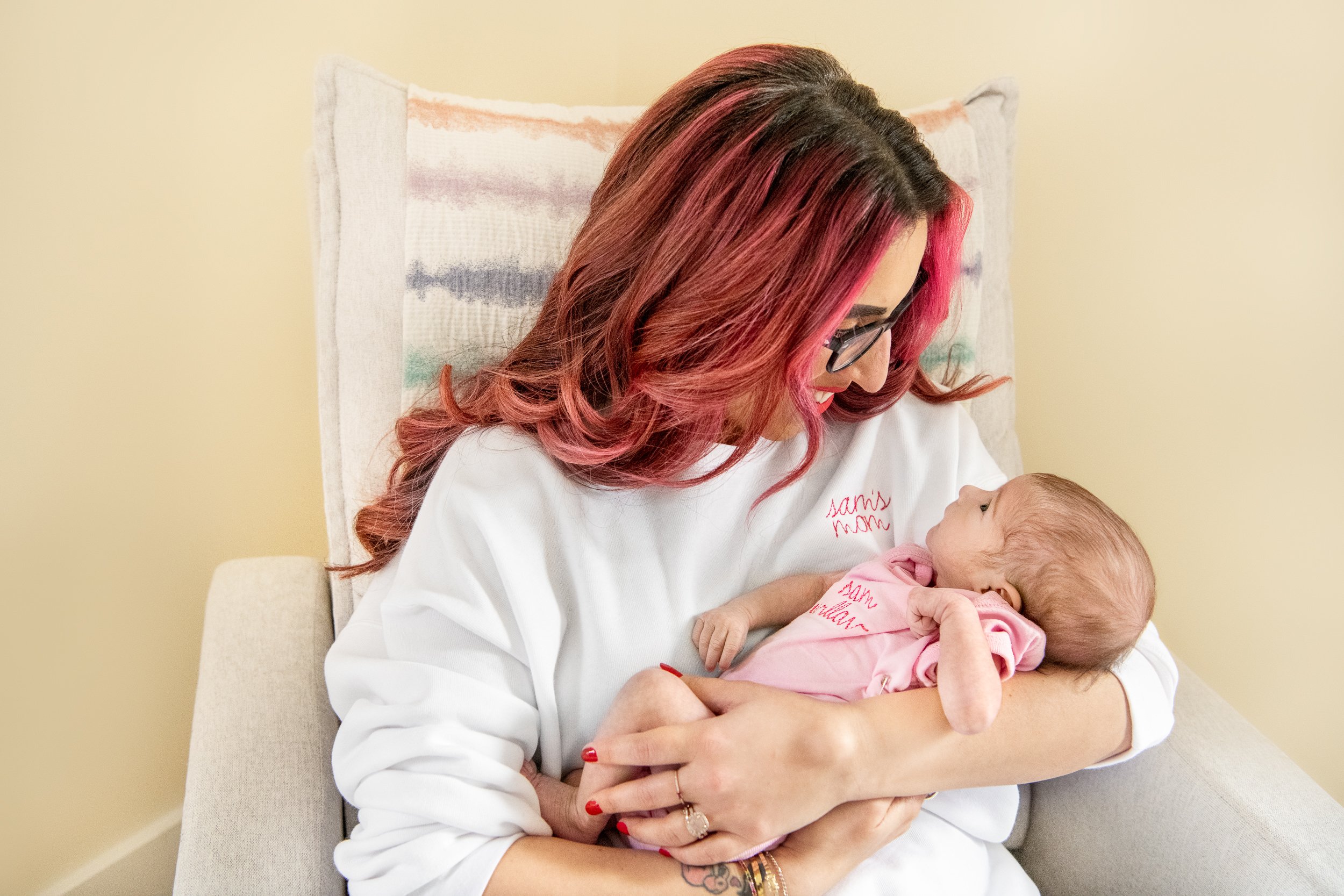  A mother with red hair holds her newborn baby girl captured by Nicole Hawkins Photography. New Jersey Newborn photographer spunky momma #nicolehawkinsphotography #NJfamilyphotographer #inhomenewbornsession #nicolehawkinsnewborns #NJnewbornphotograph