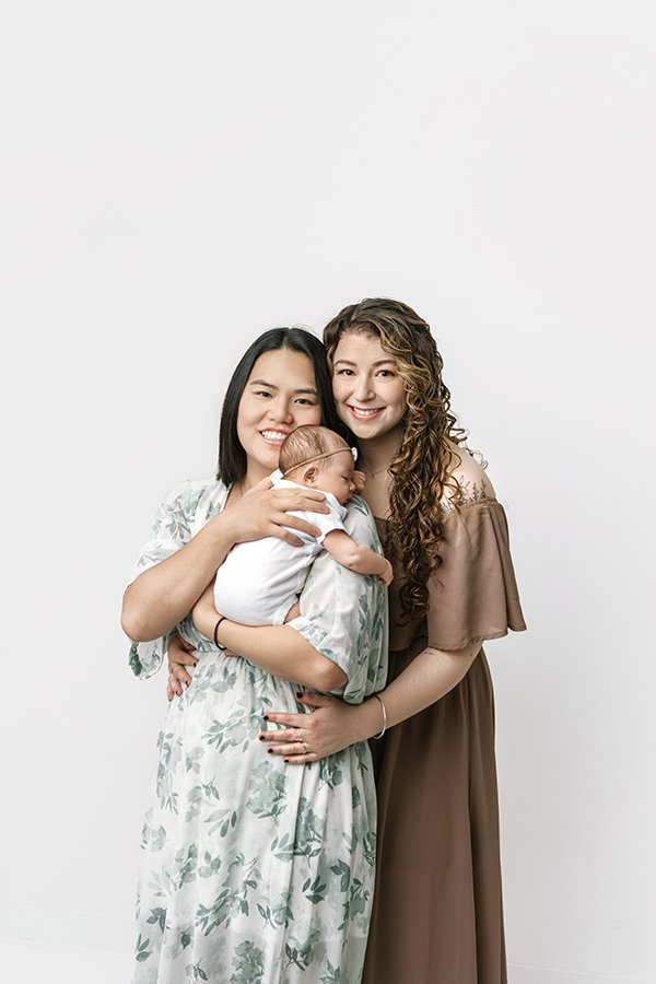  Two mothers with their baby girl during a newborn studio session with Nicole Hawkins Photography. two mothers and baby studio newborns #NicoleHawkinsPhotography #studionewbornportraits #NJstudiophotographer #NJnewborns #NicoleHawkinsNewborns 