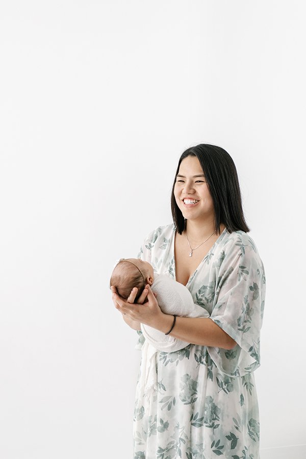  In a New Jersey Studio, Nicole Hawkins Photography captures a new mother holding her baby girl. Maplewood NJ family photographers new parent #NicoleHawkinsPhotography #studionewbornportraits #NJstudiophotographer #NJnewborns #NicoleHawkinsNewborns 