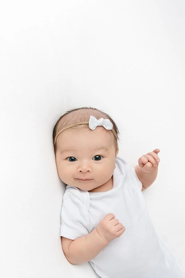  New Jersey Photographer Nicole Hawkins Photography captures a baby smirking during a newborn session. baby smiles baby portraits in NJ #NicoleHawkinsPhotography #studionewbornportraits #NJstudiophotographer #NJnewborns #NicoleHawkinsNewborns 
