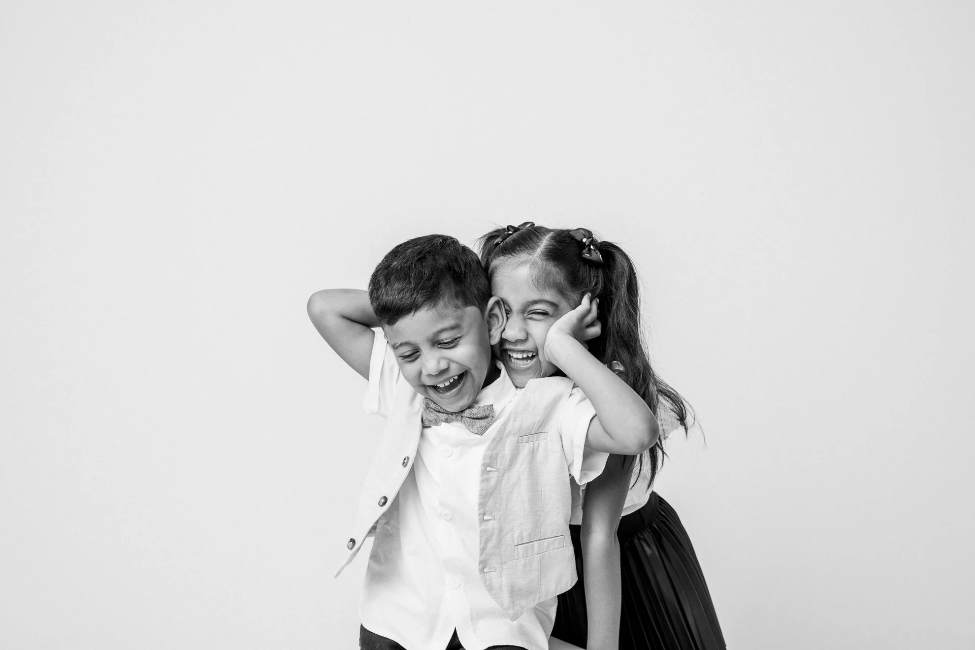  Joyful Indian-Guyanese siblings being playful in New Jersey portrait studio. 