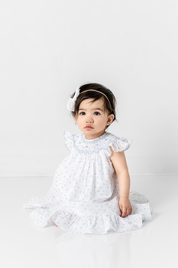  Nicole Hawkins Photography captures a milestone portrait of a baby girl in a flutter gown. black haired baby bow with dress NJ photographers #nicolehawkinsphotography #nicolehawkinsbirthday #nicolehawkinsportraits #NJstudiophotography #1stbirthday 