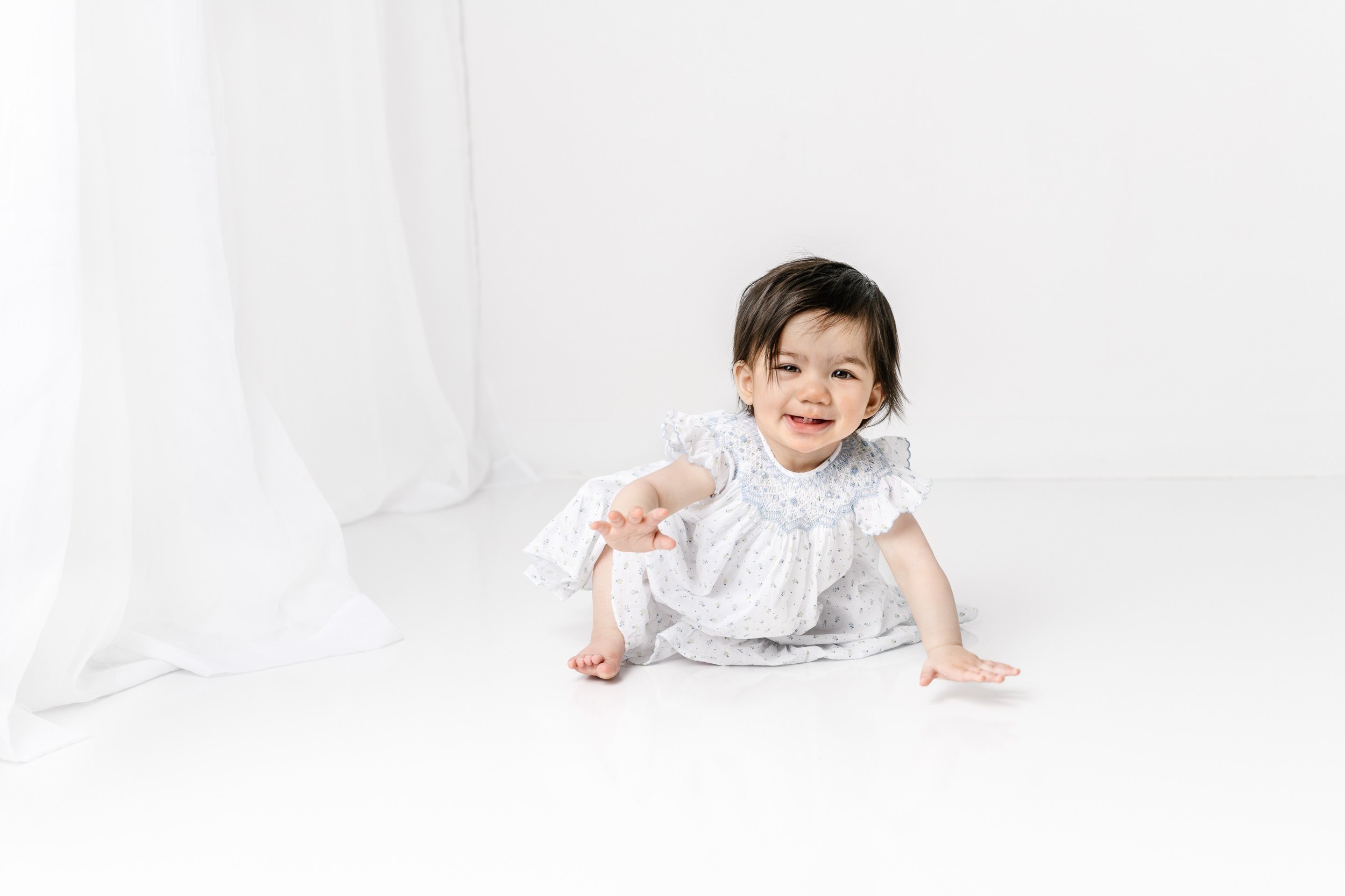  In a studio with lots of natural light, Nicole Hawkins Photography captures birthday portraits. cute baby outfits crawling baby girl #nicolehawkinsphotography #nicolehawkinsbirthday #nicolehawkinsportraits #NJstudiophotography #1stbirthday 
