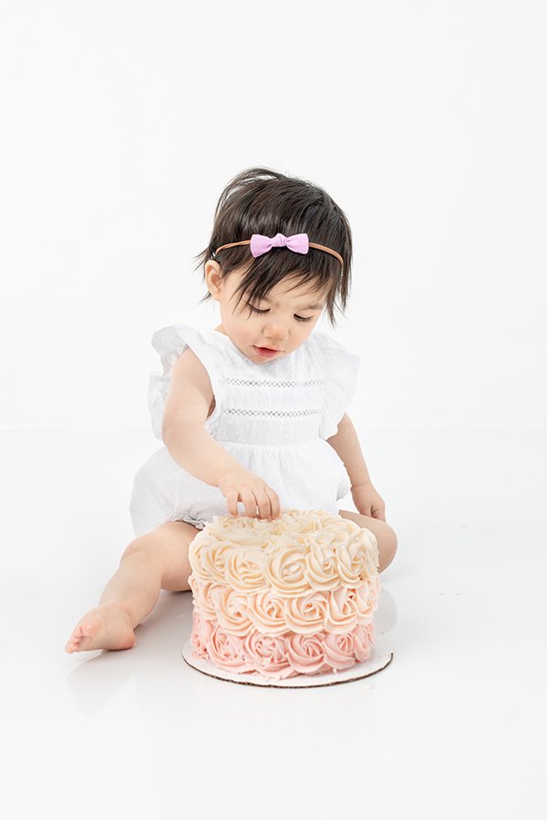  Pink rosette smash cake for a baby girl in New Jersey by Nicole Hawkins Photography. pink rosette cake studio smash cake session NJ #nicolehawkinsphotography #nicolehawkinsbirthday #nicolehawkinsportraits #NJstudiophotography #1stbirthday 