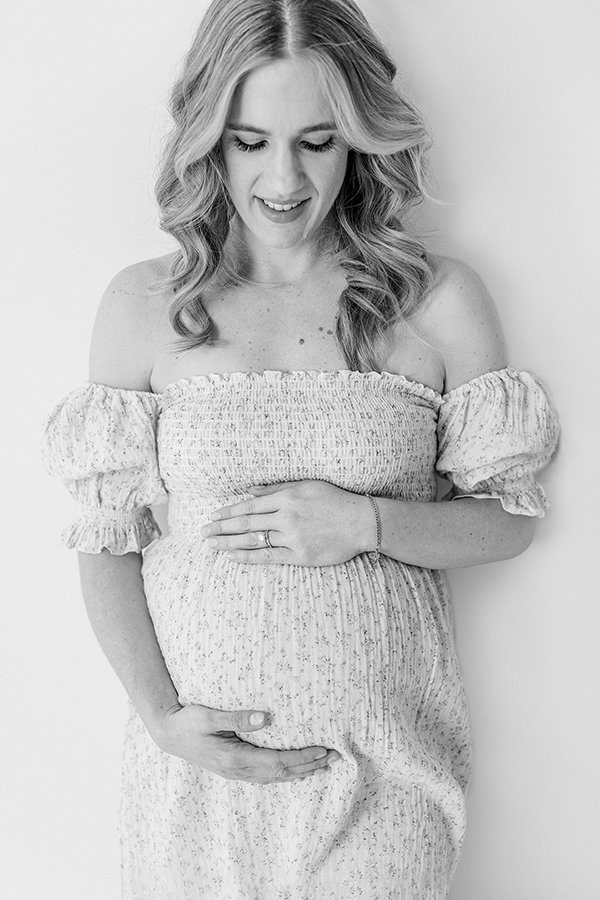  Nicole Hawkins Photography captures a close-up portrait of a pregnant woman wearing an off-the-shoulder gown. strapless maternity gown belly bump #nicolehawkinsphotography #nicolehawkinsmaternity #maternityportraits #NJstudiophotography #mommatobe 