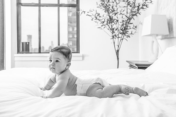  Six-month milestone session with Nicole Hawkins Photography with New Jersey skyline out the window. authentic baby portrait #NicoleHawkinsPhotography #NicoleHawkinsMilestones #BabyMilestoneSession #NJfamilyphotographer #Inhomephotog #babyportraits 
