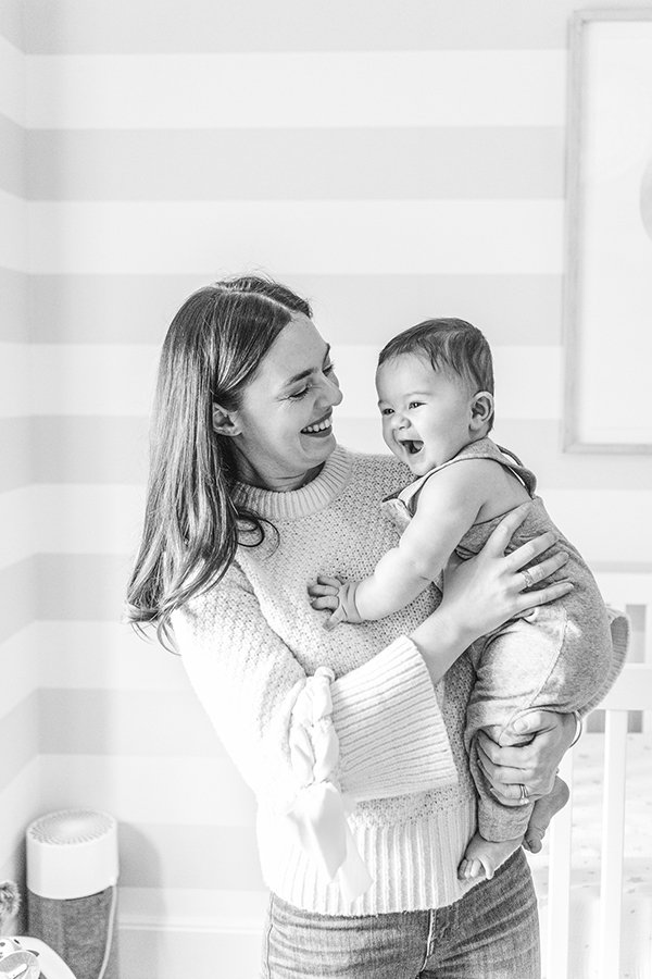  A mother holds her young boy in her arms and smiles down at him by Nicole Hawkins Photography. mother and child #NicoleHawkinsPhotography #NicoleHawkinsMilestones #BabyMilestoneSession #NJfamilyphotographer #Inhomephotography #babyportraits 