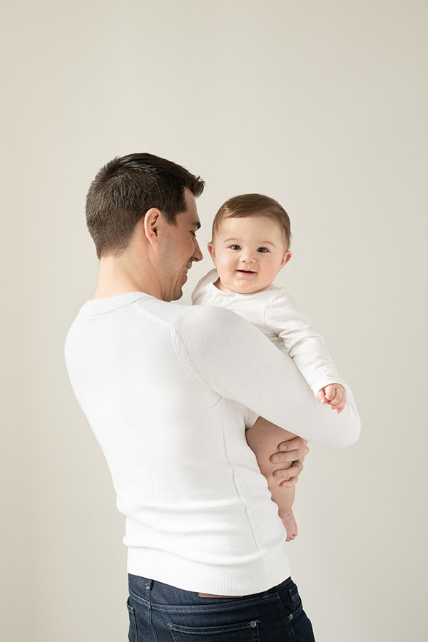  A portrait of a father holding his chunky little son by Nicole Hawkins Photography in New Jersey. father and son daddy #NicoleHawkinsPhotography #NicoleHawkinsMilestones #BabyMilestoneSession #NJfamilyphotographer #Inhomephotography #babyportraits 