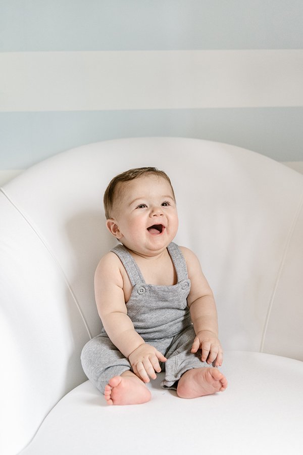  Nicole Hawkins Photography captures an authentic portrait of a little boy laughing on a chair in NJ. genuine baby pic #NicoleHawkinsPhotography #NicoleHawkinsMilestones #BabyMilestoneSession #NJfamilyphotographer #Inhomephotography #babyportraits 