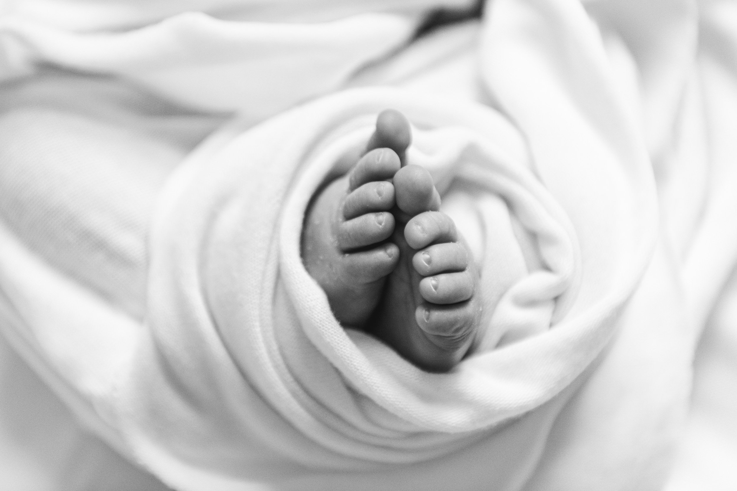  Wrapped up baby feet during an in-home newborn session with Nicole Hawkins Photography. baby feet detailed portrait black and white #NewbornSession #NJfamilyphotographer #Inhomebabyphotography #newborn #NicoleHawkinsPhotography #NicoleHawkinsNewborn