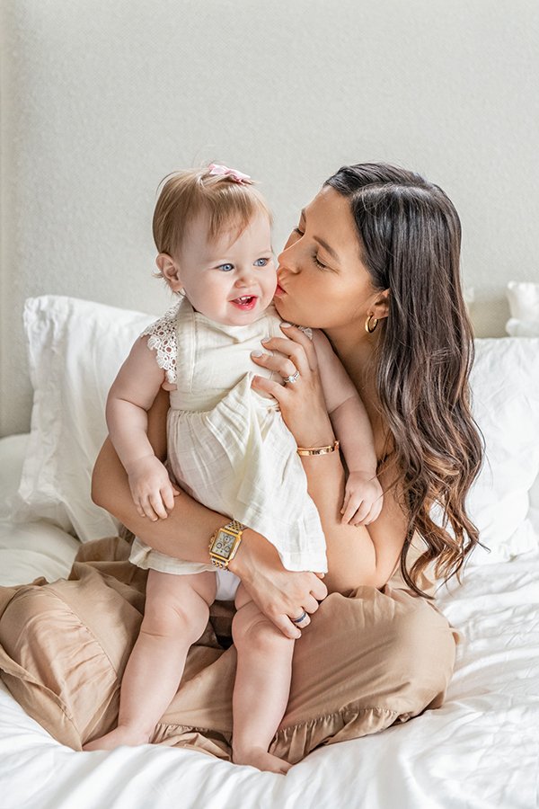  The toddler girl is kissed by her mother during an in-home session with Nicole Hawkins Photography. high end NJ photographer #NewbornSession #NJfamilyphotographer #Inhomebabyphotography #newborn #NicoleHawkinsPhotography #NicoleHawkinsNewborns 