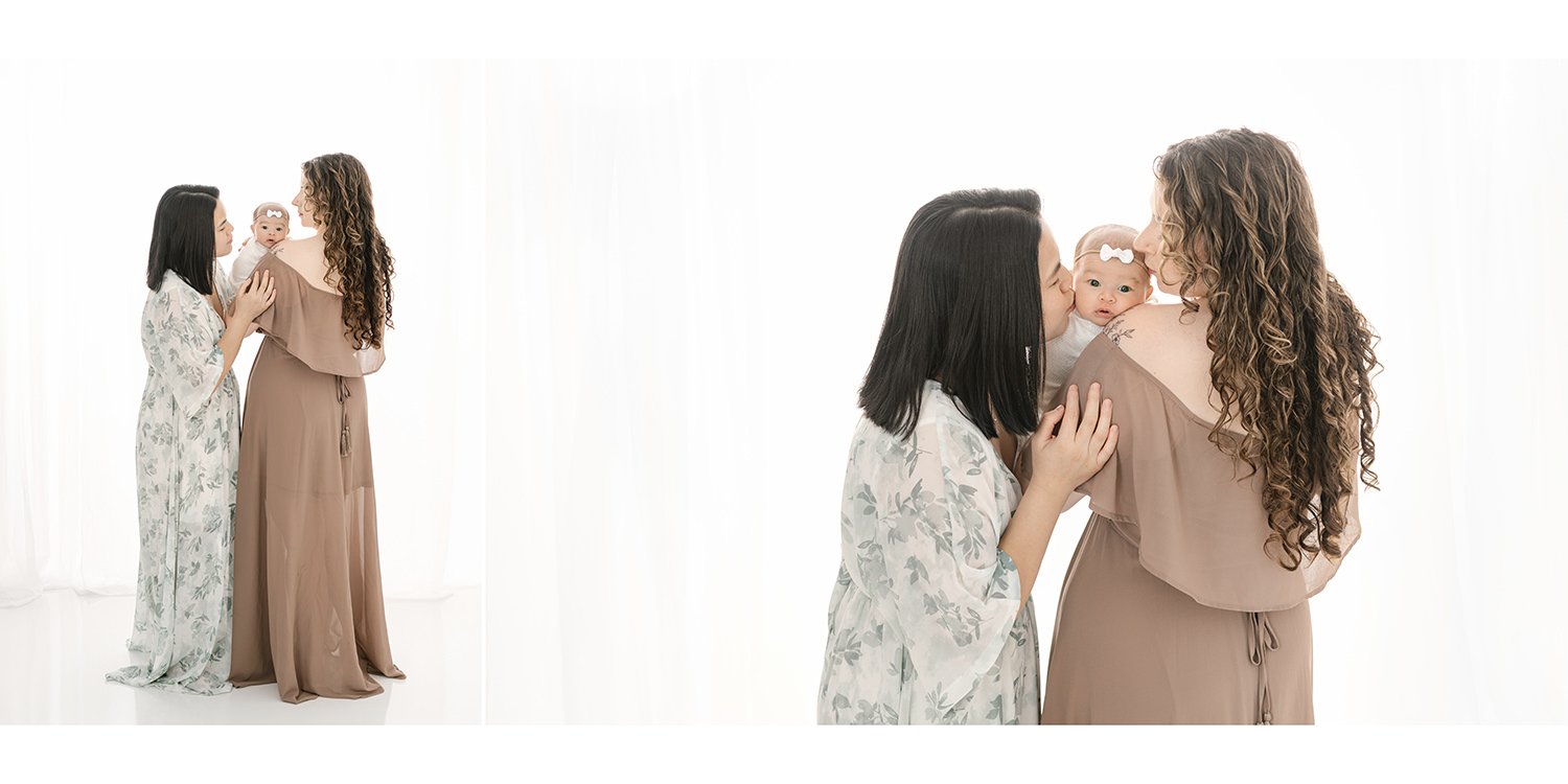  Moms wear coordinating gowns and snuggle their newborn daughter in a crisp white studio session #studioportraits #newborn #maplewoodNJ #nicolehawkinsphotography #newjerseyphotographer  #portraitphotography #heirloomphotography 