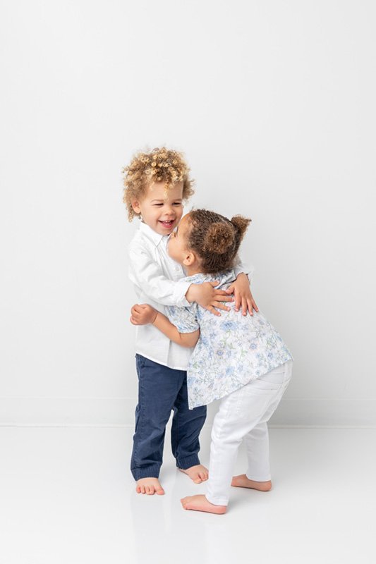  Two-year-old twins hug each other during a studio photography session with Nicole Hawkins Photography. sibling photography twins boy girl #NicoleHawkinsPhotography #NicoleHawkinsBabies #StudioPhotography #NewJerseyPhotographer #twinphotography   