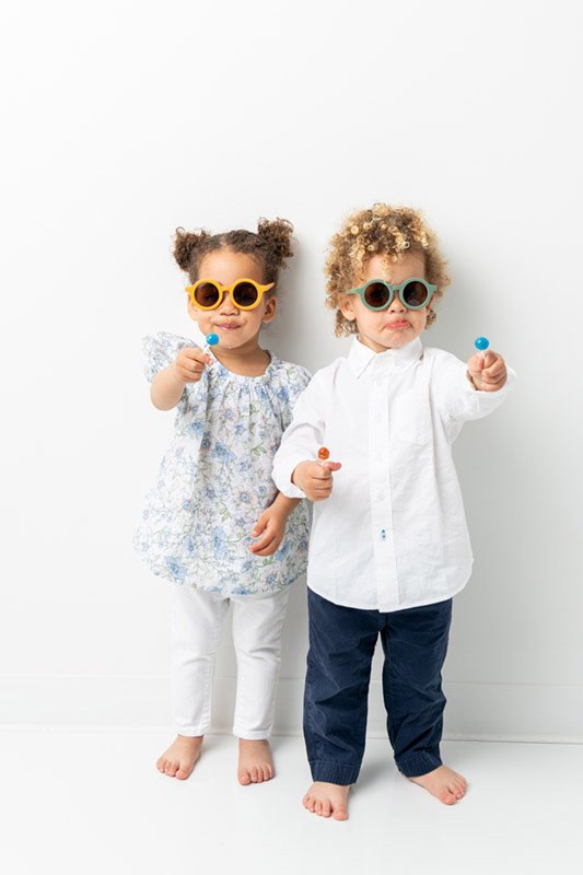  Nicole Hawkins Photography captures a portrait with a little boy and girl wearing sunglasses and eating suckers. children photographer NJ #NicoleHawkinsPhotography #NicoleHawkinsBabies #StudioPhotography #NewJerseyPhotographer #twinphotography   