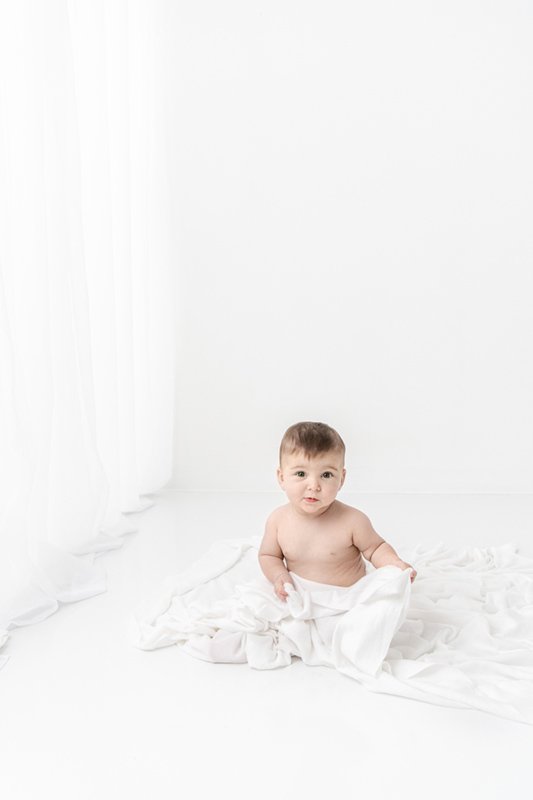  Professional studio photographer Nicole Hawkins Photography captures light and airy shots of a baby girl. light and bright baby pics #sixmonthbabyportraits #NJPhotographer #NicoleHawkinsPhotography #NicoleHawkinsBabies #BabyStudioPhotography    