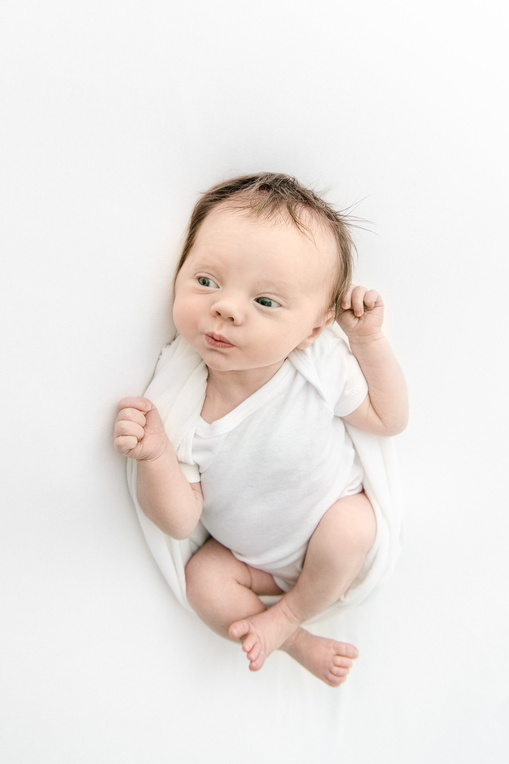 Baby girl with blue eyes and brown hair awake during a studio newborn session in New Jersey by Nicole Hawkins Photography. awake baby #NicoleHawkinsPhotography #NicoleHawkinsNewborns #StudioPhotography #NewYorkPhotographer #NJphotographers #newborn 