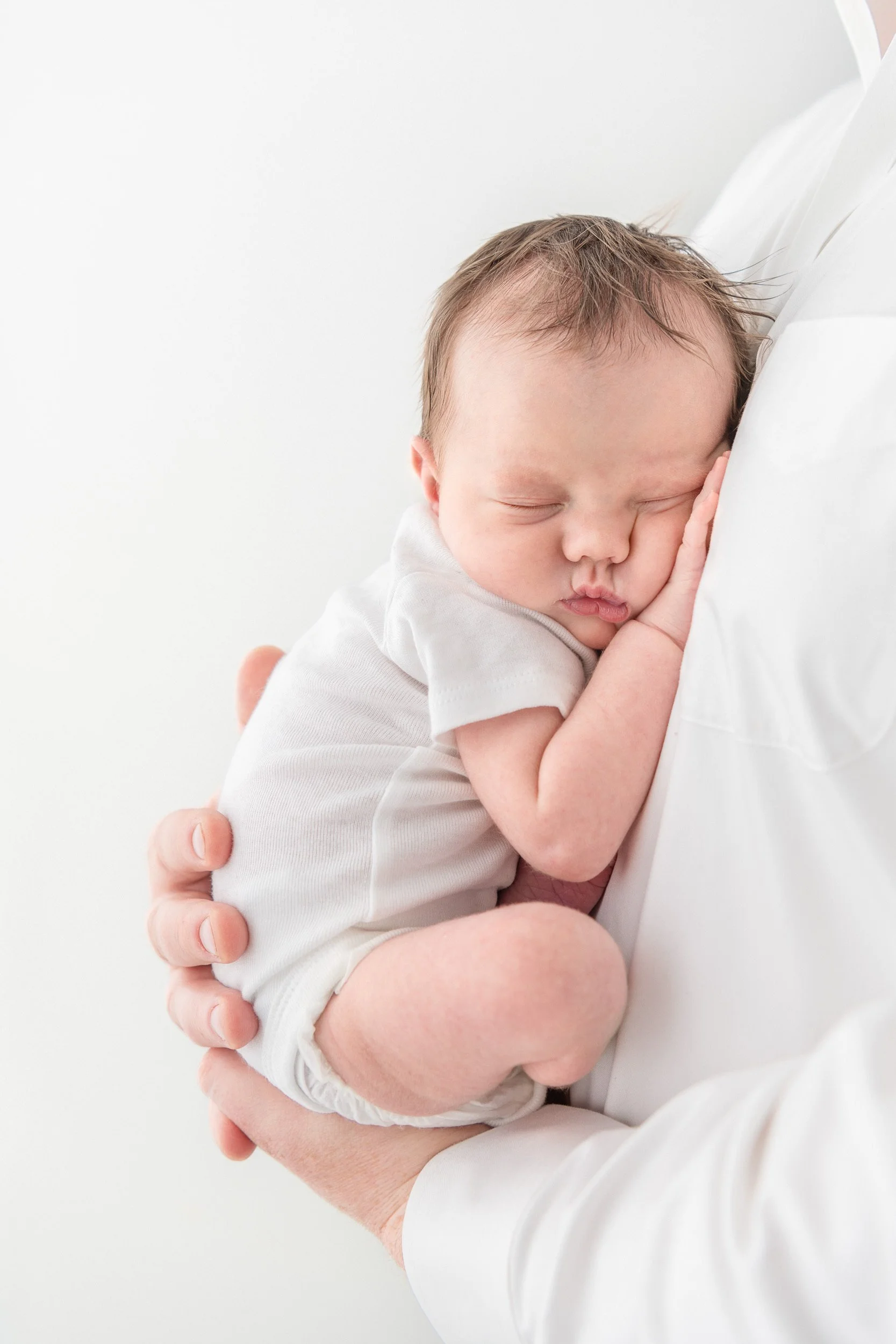  Nicole Hawkins Photography captures a little girl snuggled up on her dad's chest sleeping. baby and daddy squished up baby #NicoleHawkinsPhotography #NicoleHawkinsNewborns #StudioPhotography #NewYorkPhotographer #NJphotographers #newborn 