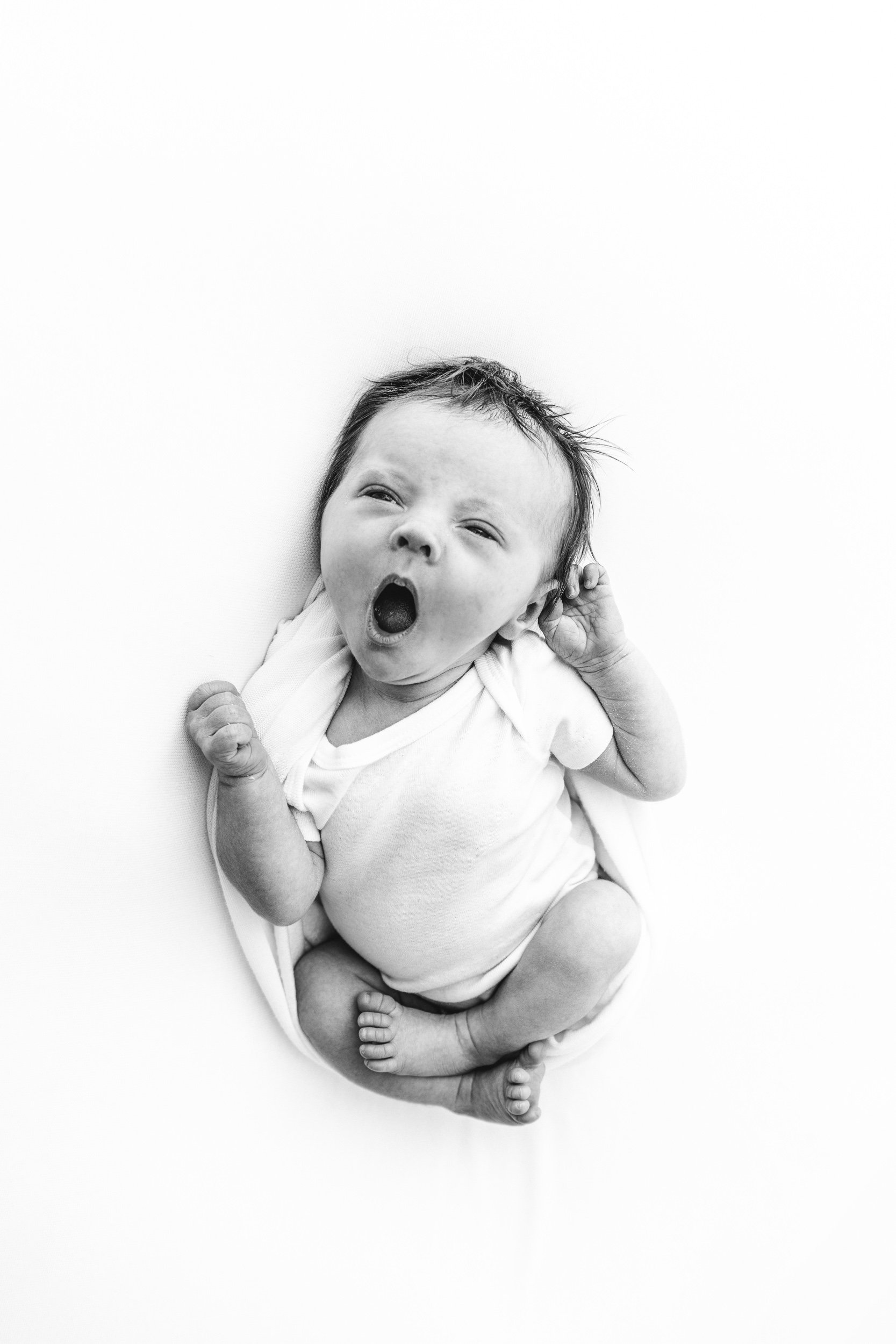  A baby girl yawns during a newborn session in the New Jersey area by Nicole Hawkins Photography. yawning baby with hair #NicoleHawkinsPhotography #NicoleHawkinsNewborns #StudioPhotography #NewYorkPhotographer #NJphotographers #newborn 