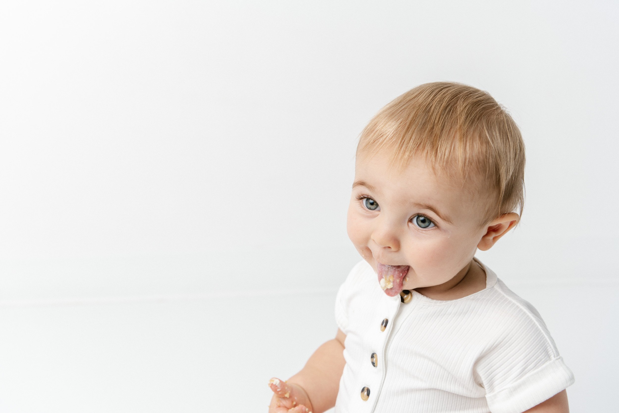  While trying some birthday cake a little boy spits the cake out captured by Nicole Hawkins Photography. NJ cake smash #NicoleHawkinsPhotography #NicoleHawkinsBabies #BirthdayStudioPhotography #smashcake #firstbirthday #studiobabiesandchildren 