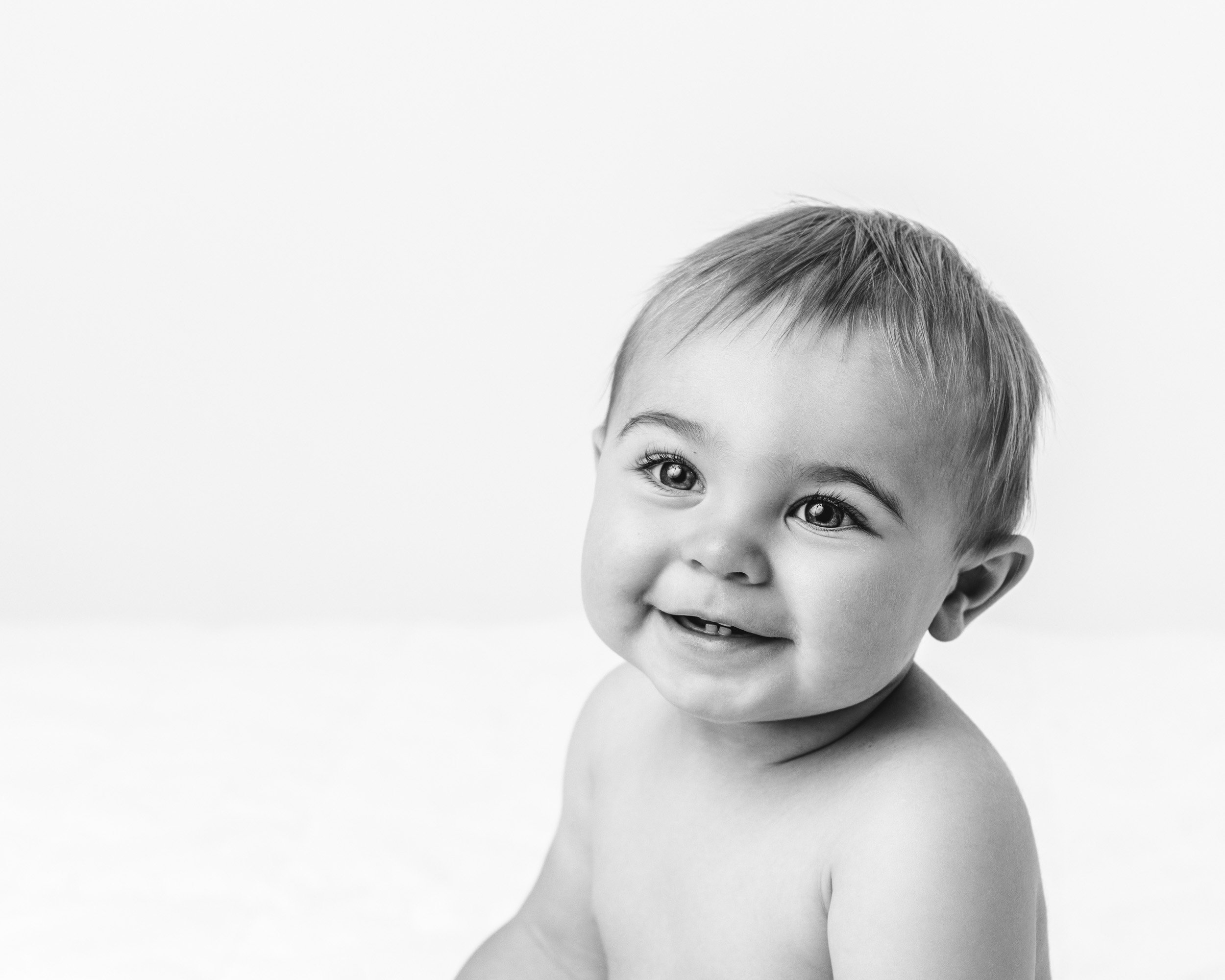  A portrait of a shirtless baby boy in a studio by Nicole Hawkins Photography. baby face portraits near New York #NicoleHawkinsPhotography #NicoleHawkinsBabies #BirthdayStudioPhotography #smashcake #firstbirthday #studiobabiesandchildren 