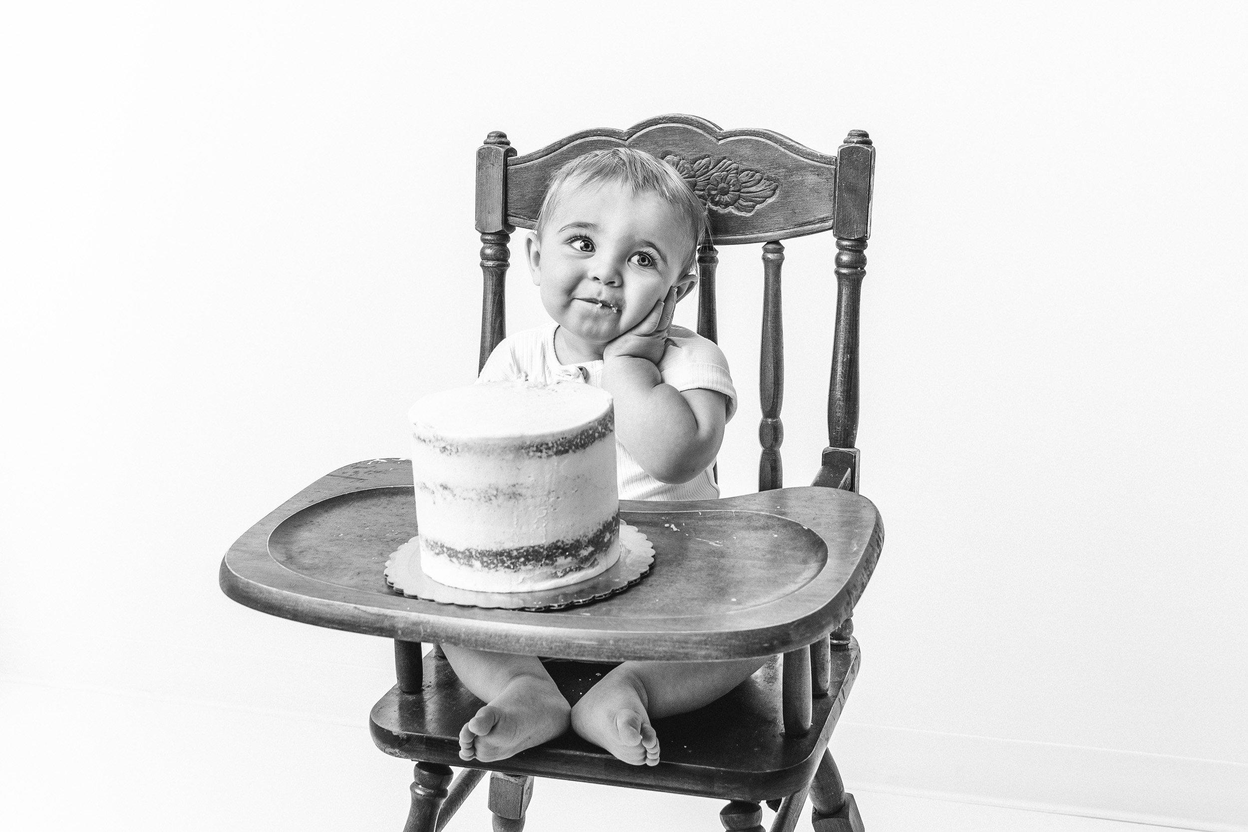  Child photographer Nicole Hawkins Photography captures a black and white portrait of a little boy and his birthday cake. #NicoleHawkinsPhotography #NicoleHawkinsBabies #BirthdayStudioPhotography #smashcake #firstbirthday #studiobabiesandchildren 