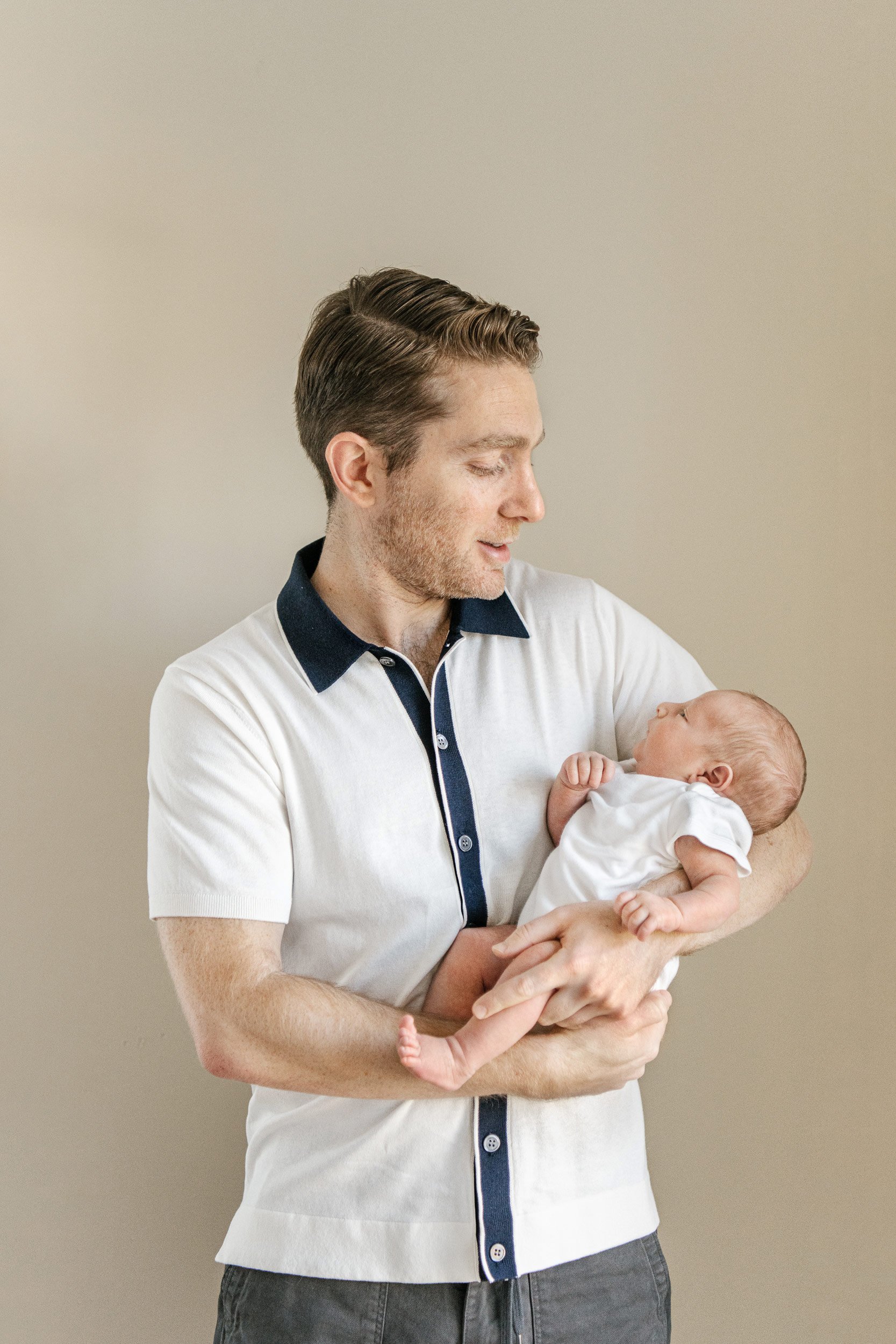  Nicole Hawkins Photography captures a father with his newborn son in his Jersey Shore home. Jersey Shore Newborns #NicoleHawkinsPhotography #InHomeNewborn #JerseyShoreNewborns #MontclairPhotographers #NewbornPhotography #baby #newborn 