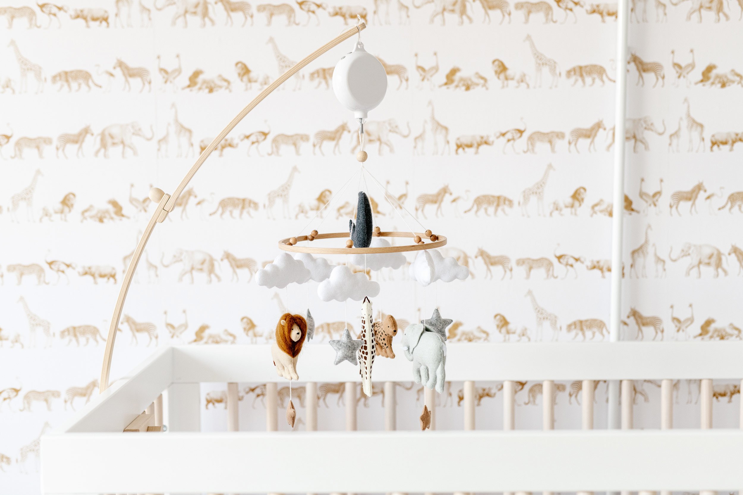  Baby nursery with jungle animal wall paper and mobile by Nicole Hawkins Photography in NY. jungle nursery zoo nursery baby wallpaper #NicoleHawkinsPhotography #InHomeNewborns #NurseryNewborns #NYCbabyphotography #babyportraits #ZooNursery 