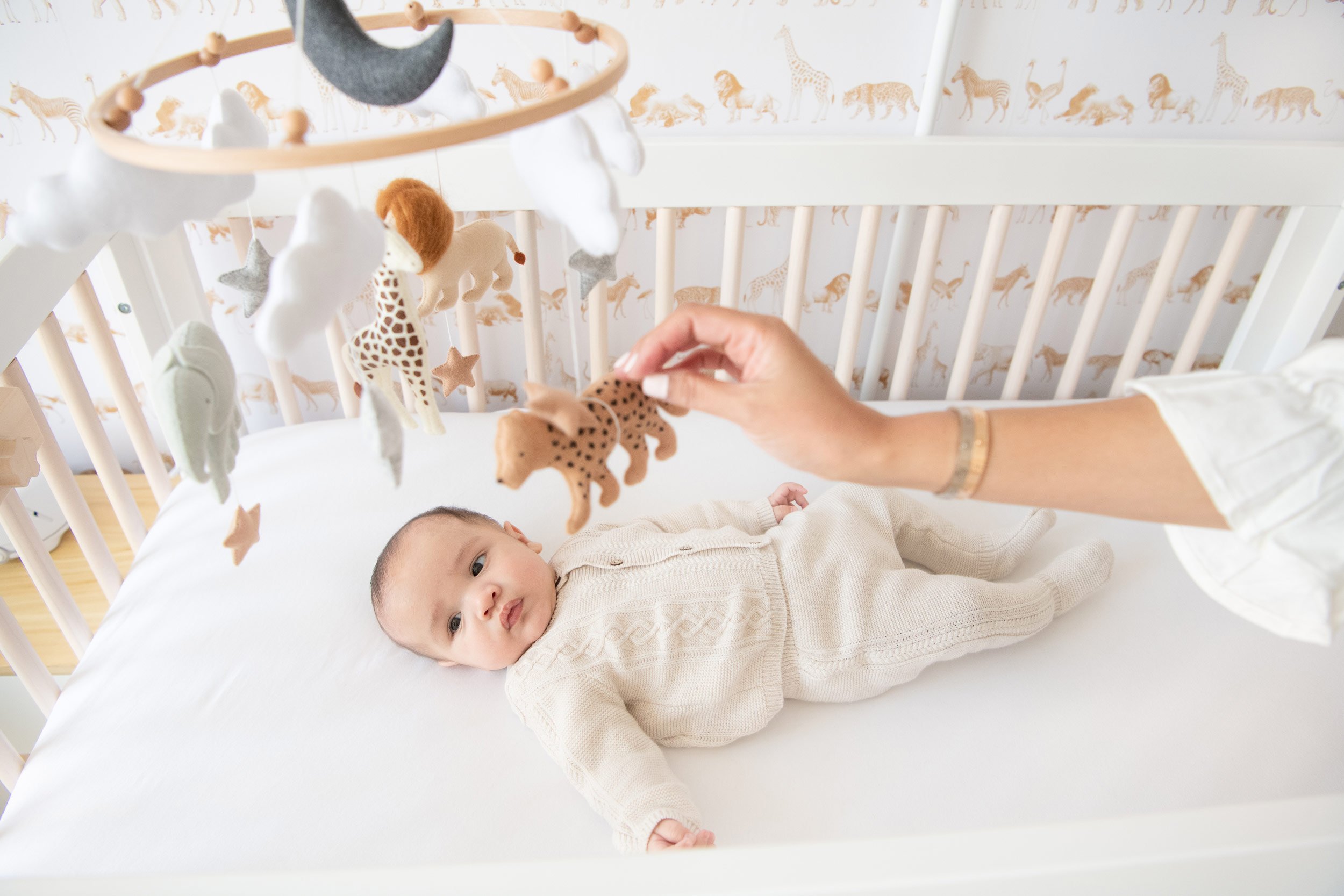  In a New York Nursery, a baby boy looks at his animal mobile by Nicole Hawkins Photography. unique mobile animal mobile #NicoleHawkinsPhotography #InHomeNewborns #NurseryNewborns #NYCbabyphotography #babyportraits #ZooNursery #familyportraits 