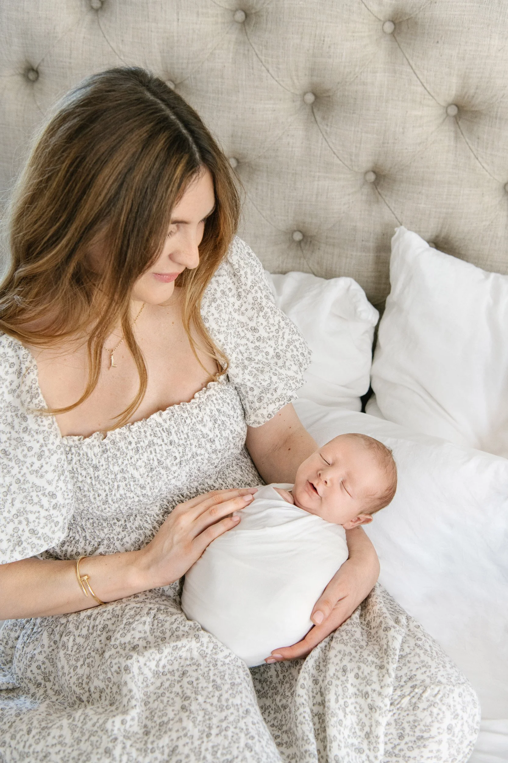  A mother snuggles her newborn baby captured by Professional photographer Nicole Hawkins Photography. clean simple modern #NicoleHawkinsPhotography #InHomeNewborn #JerseyShoreNewborn #MontclairPhotographers #NewbornPhotography #baby #newborn 
