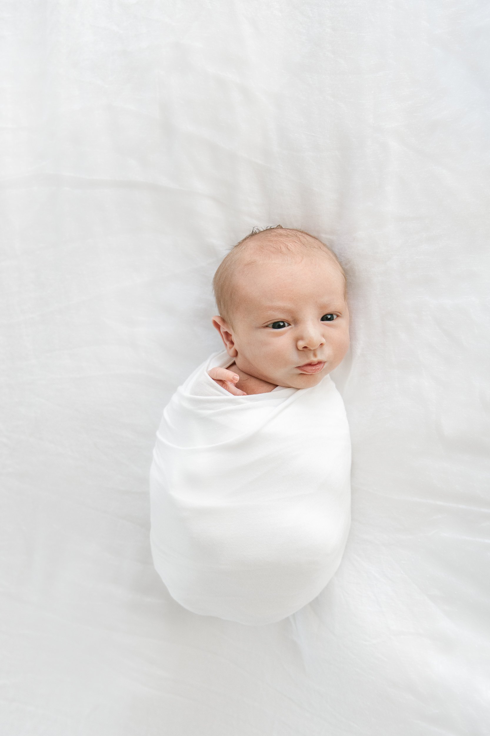  Baby boy swaddled up for a modern newborn photography session with Nicole Hawkins Photography. modern newborns #NicoleHawkinsPhotography #InHomeNewborn #JerseyShoreNewborn #MontclairPhotographers #NewbornPhotography #baby #newborn 