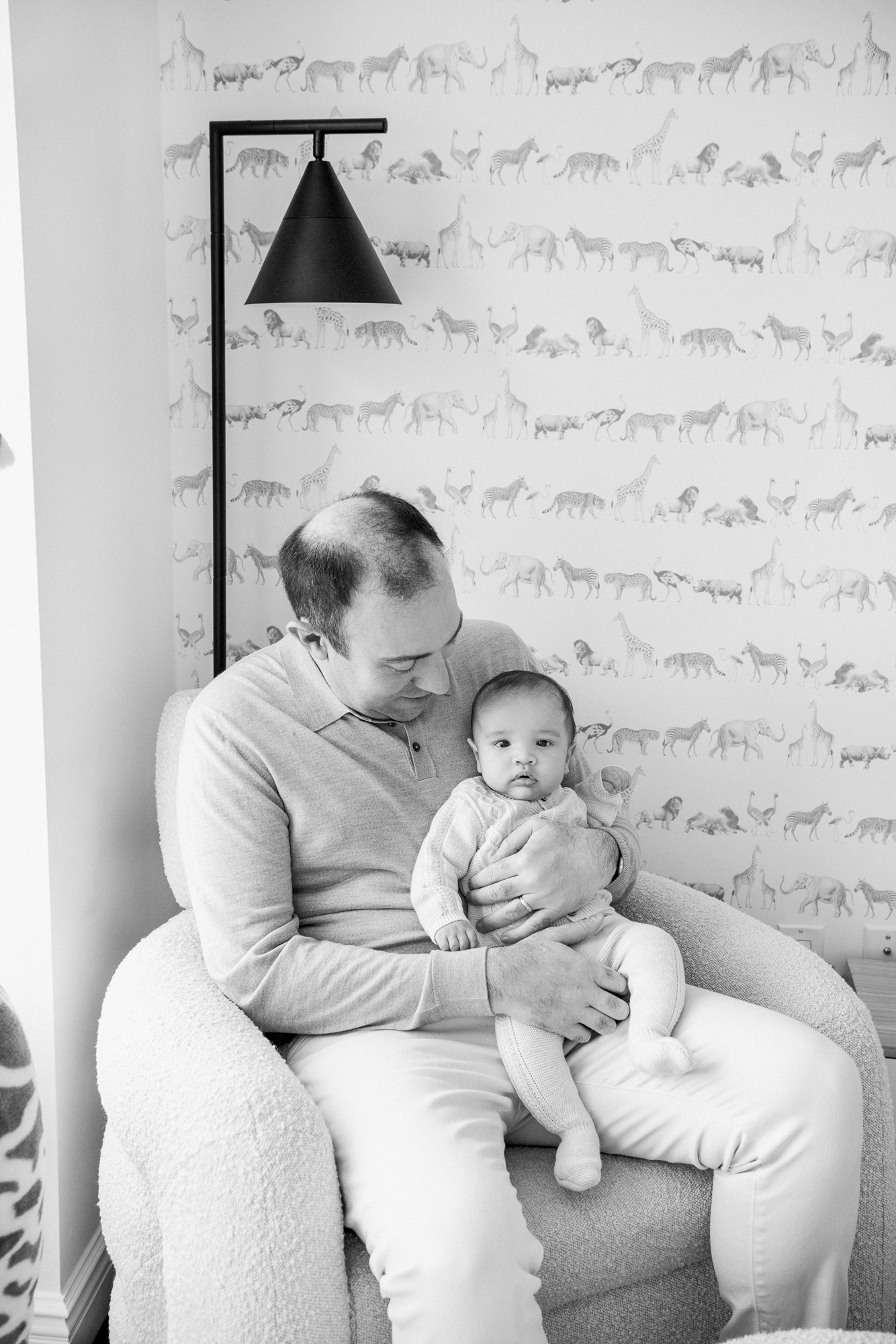  A family of three sitting together in their own home in New York captured by Professional Nicole Hawkins Photography. high-end #NicoleHawkinsPhotography #InHomeNewborns #NurseryNewborns #NYCbabyphotography #babyportraits #ZooNursery #familyportraits