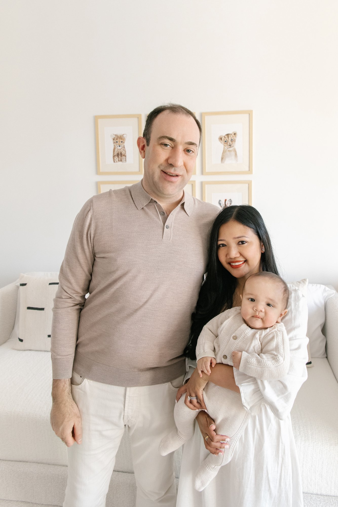  Modern timeless family portrait with a newborn baby in the nursery by Nicole Hawkins Photography. clean family portrait #NicoleHawkinsPhotography #InHomeNewborns #NurseryNewborns #NYCbabyphotography #babyportraits #ZooNursery #familyportraits 