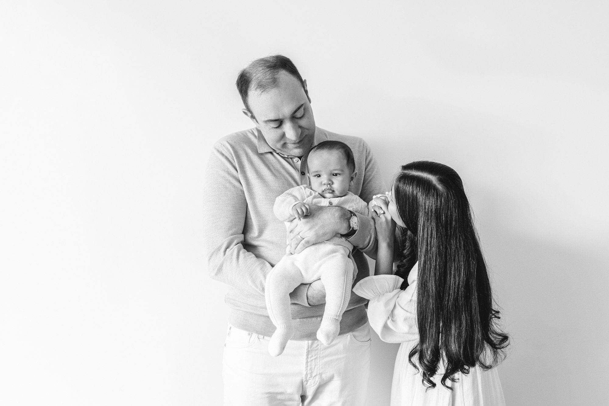  In New York Nicole Hawkins Photography captures a portrait of a family of three in black and white. modern family pics #NicoleHawkinsPhotography #InHomeNewborns #NurseryNewborns #NYCbabyphotography #babyportraits #ZooNursery #familyportraits 