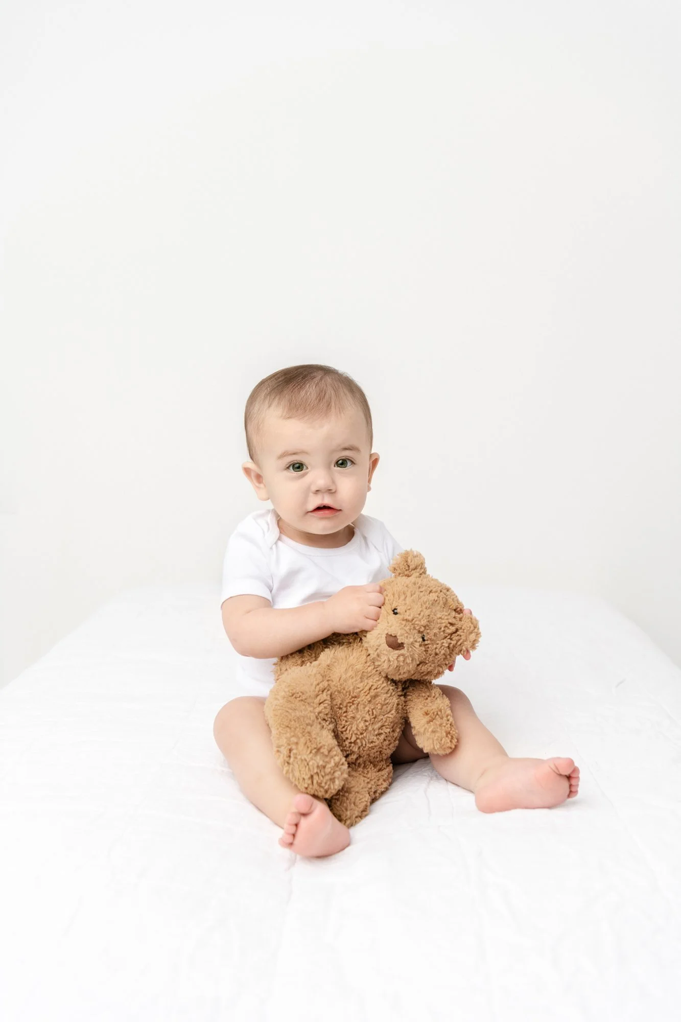  Nicole Hawkins Photography captures a timeless portrait of a baby with a teddy bear. simple baby props #NicoleHawkinsPhotography #firstbirthday #babyportraits #NJphotographers #lifestylephotography #studiobabies #childrenphotography 