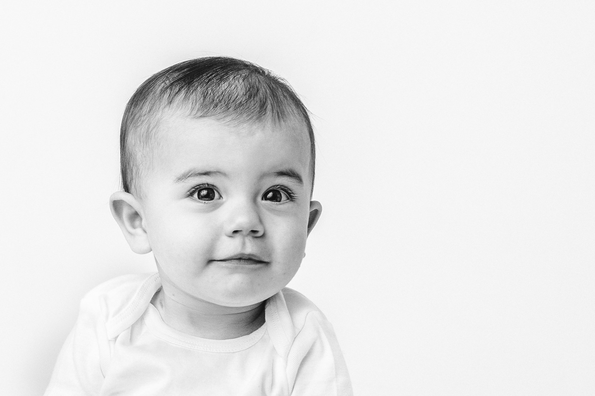 In a New Jersey studio, Nicole Hawkins Photography captures a portrait of a baby girl with big eyes. baby face portraits #NicoleHawkinsPhotography #firstbirthday #babyportraits #NJphotographers #lifestylephotography #studiobabies #childrenphotograph