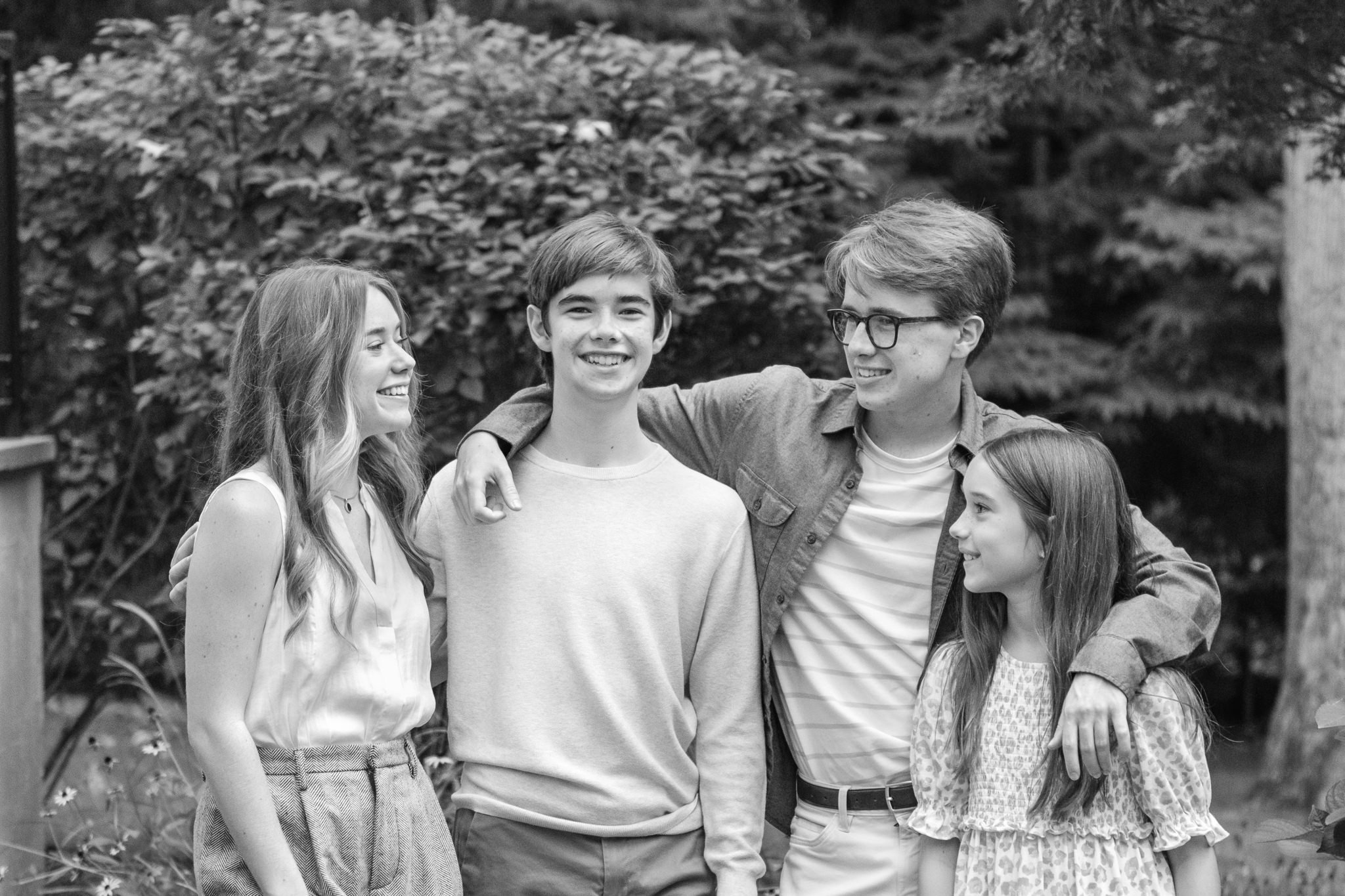  Professional family photographer Nicole Hawkins Photography captures a candid black-and-white portrait of two sisters and two brothers. #NicoleHawkinsPhotography #NicoleHawkinsFamilyPortrait #NicoleHawkinsSenior #NJPortraits #siblingportrait 