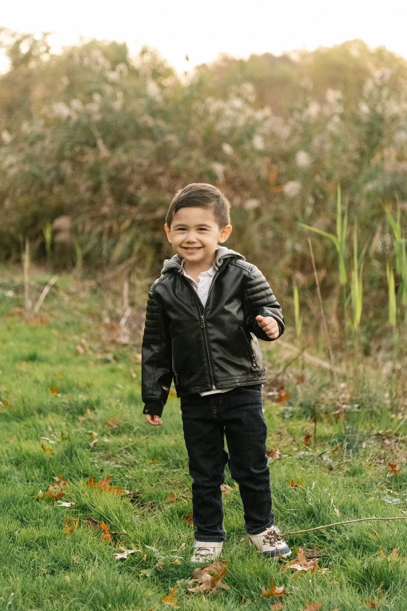  Professional photographer Nicole Hawkins Photography captured a portrait of a toddler wearing a black leather jacket. toddler boy #NicoleHawkinsPhotography #NicoleHawkinsFamilies #fallfamilyphotos #NorthernNewJerseyPhotography #outdoorfamilyportrait