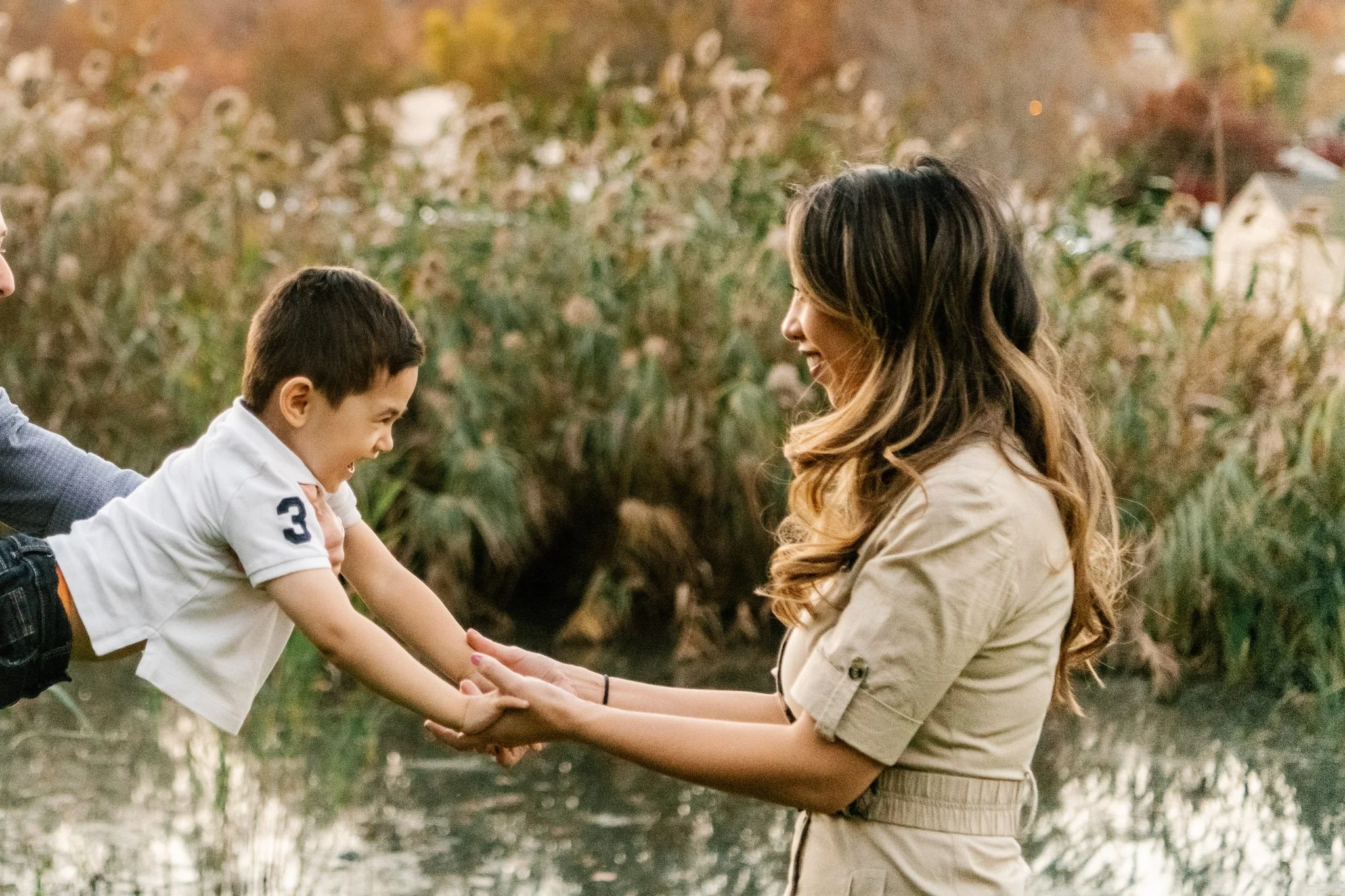  Nicole Hawkins Photography captures a little boy reaching for his mother during an outdoor fall family session. northern NJ #NicoleHawkinsPhotography #NicoleHawkinsFamilies #fallfamilyphotos #NorthernNewJerseyPhotography #outdoorfamilyportraits 
