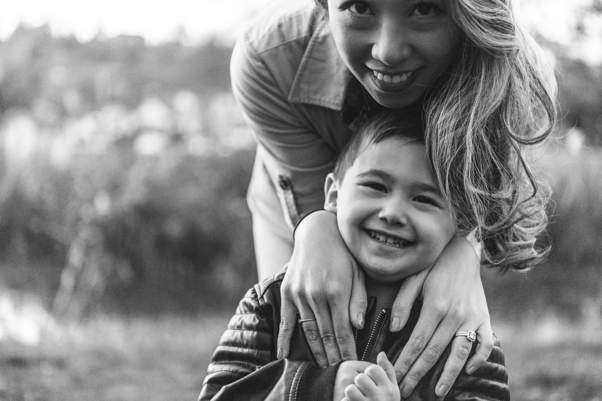 Black and white portrait of a mother hugging her little boy by Nicole Hawkins Photography. mother and boy #NicoleHawkinsPhotography #NicoleHawkinsFamilies #fallfamilyphotos #NorthernNewJerseyPhotography #outdoorfamilyportraits 