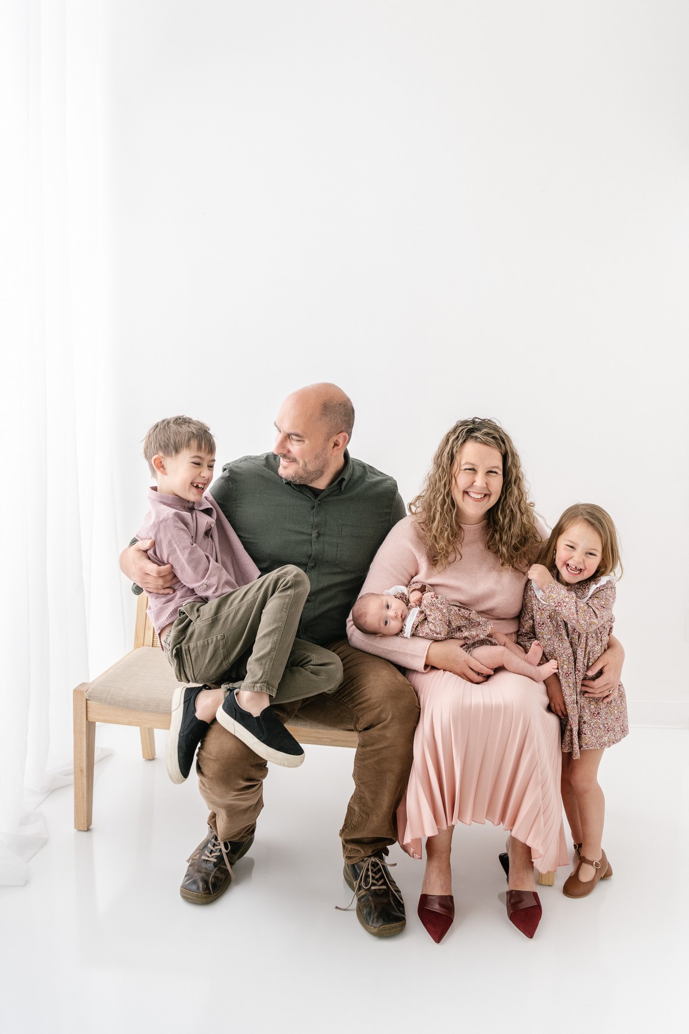  Nicole Hawkins Photography captures a family portrait in a white studio with each kid's personality shine. personality portraits #NicoleHawkinsPhotography #NicoleHawkinsFamily #Newborns #MaplewoodNJ #studiofamilyportraits #modernfamilyportraits 