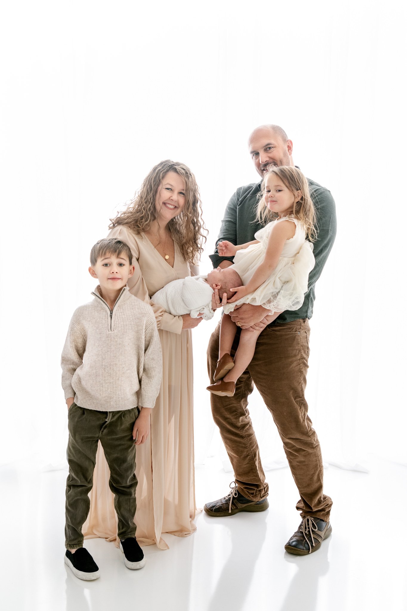  A bright white simple family portrait with a modern vibe by Nicole Hawkins Photography. simple family portrait less is more #NicoleHawkinsPhotography #NicoleHawkinsFamily #Newborns #MaplewoodNJ #studiofamilyportraits #modernfamilyportraits 