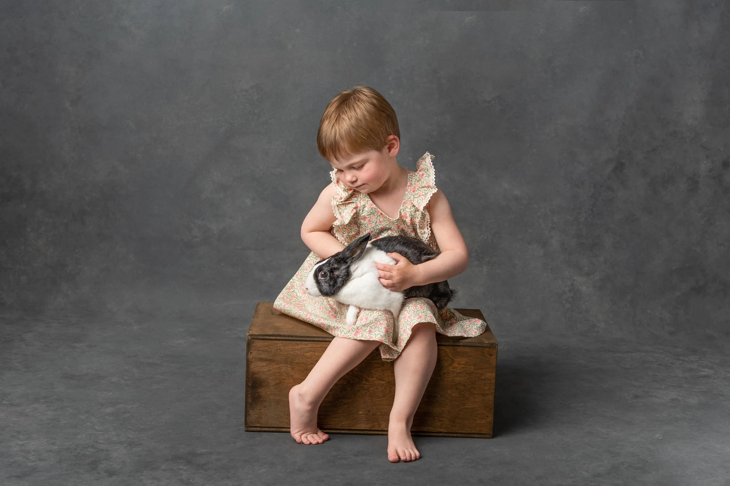  Nicole Hawkins Photography captures a portrait of a three-year-old with her pet bunny sitting on a box. pet bunny pic #NicoleHawkinsPhotography #NicoleHawkinsChildren #3rdbirthday #studioportraits #agirlandherbunny #littlegirl #milestoneportraits 
