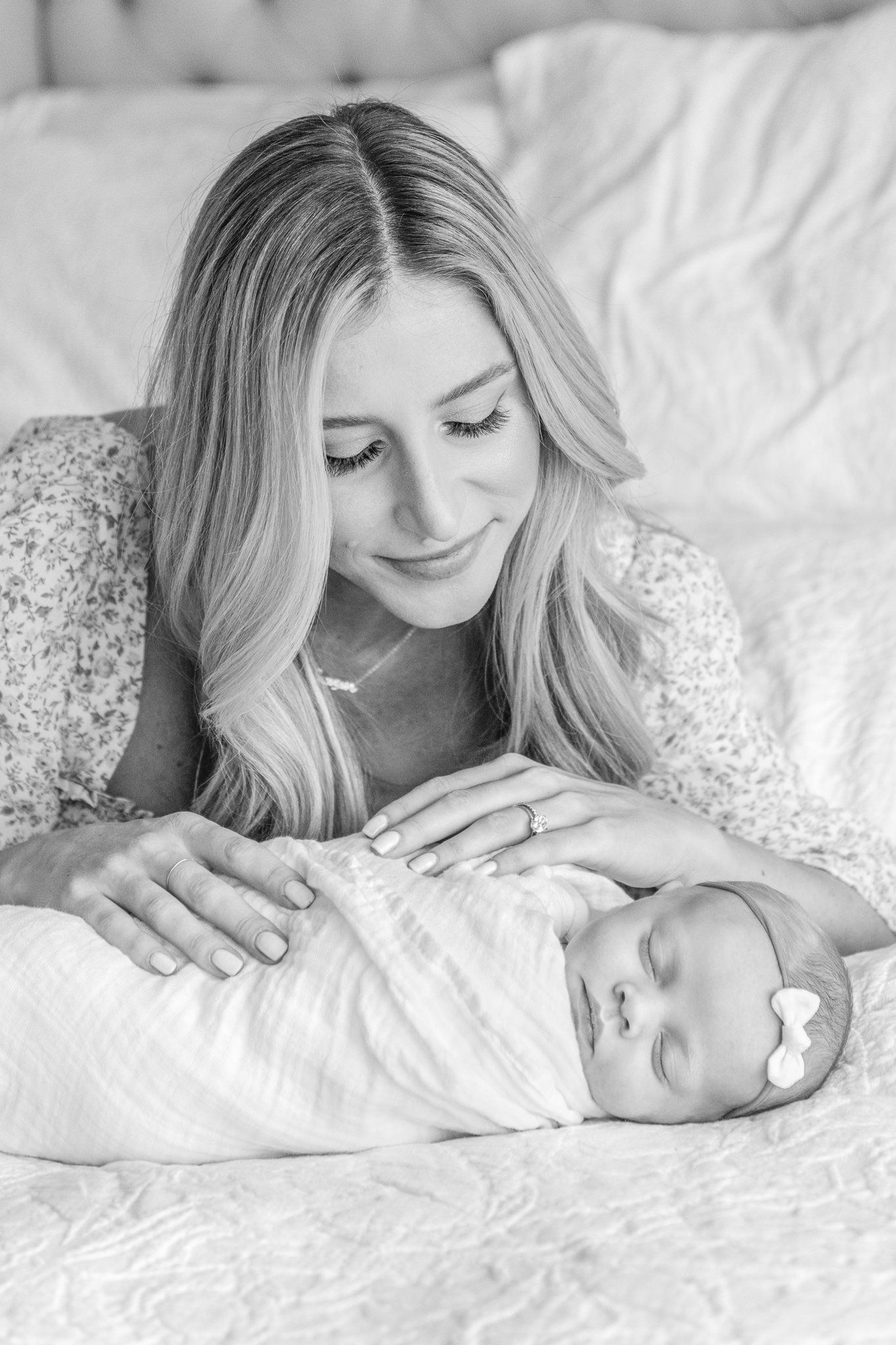  Black and White Portrait of a mother looking at her baby girl captured by Nicole Hawkins Photography. mother and baby on bed #NicoleHawkinsPhotography #NicoleHawkinsNewborns #InHomeNewborns #NewJerseyNewborns #NewYorkNewborns #babygirlnewborns 
