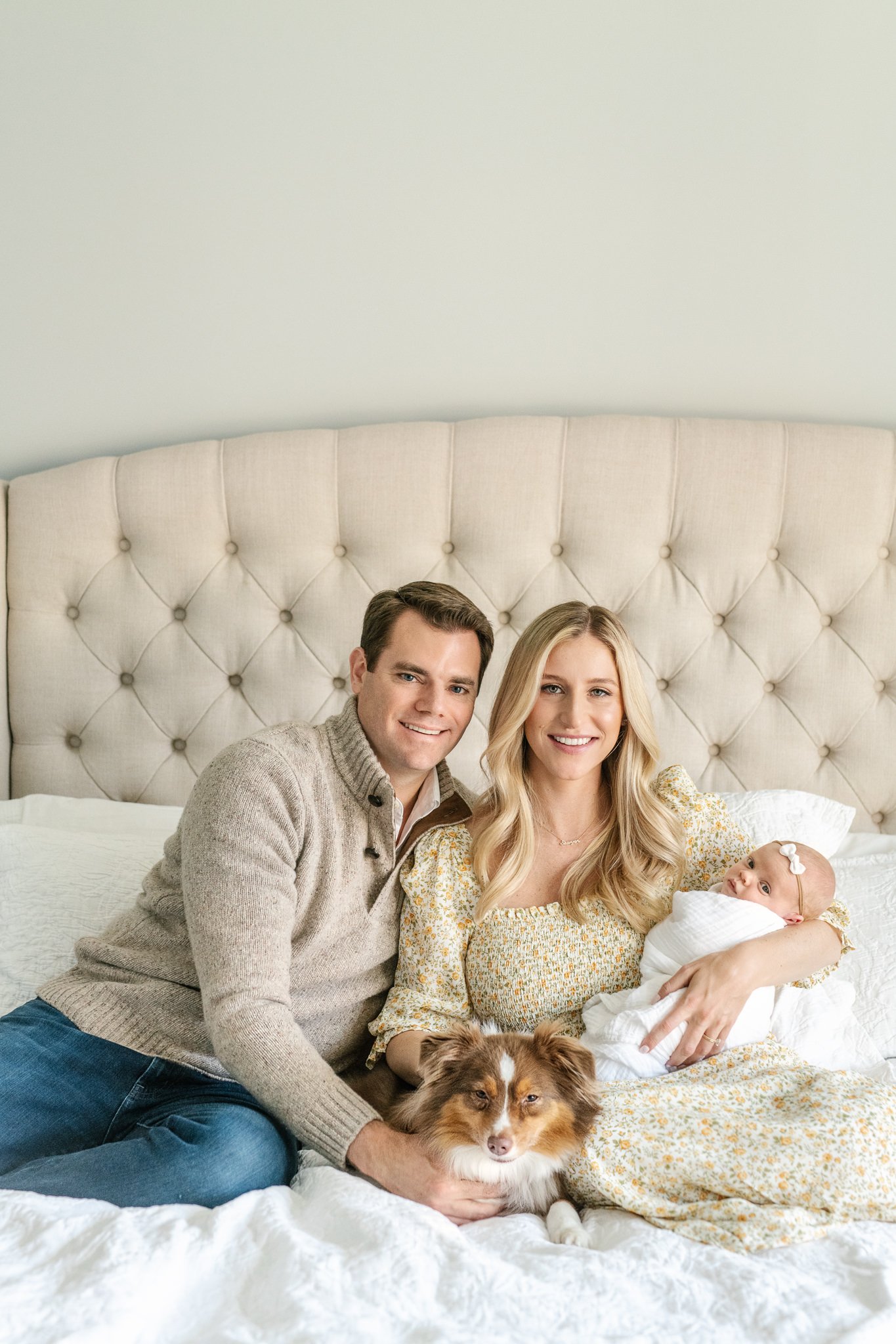  In-home newborn photographer in the New Jersey area captures a family sitting on the bed together by Nicole Hawkins photography. #NicoleHawkinsPhotography #NicoleHawkinsNewborns #InHomeNewborns #NewJerseyNewborns #NewYorkNewborns #babygirlnewborns 