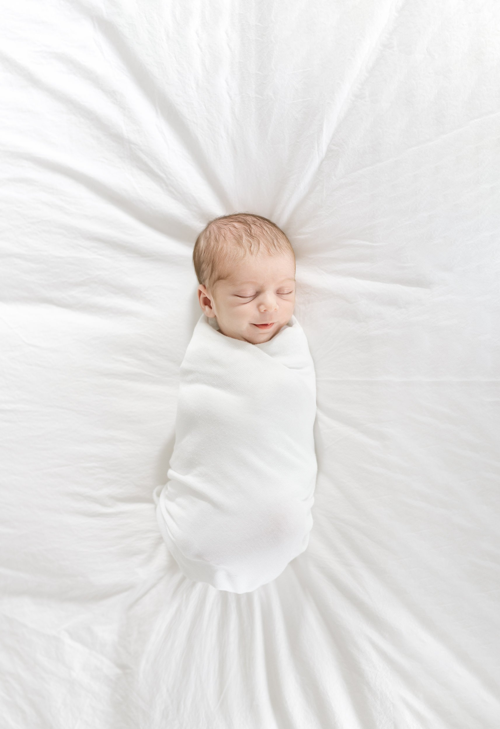  Baby swaddled and sleeping on a bed during an in-home newborn session with Nicole Hawkins Photography. baby napping on bed #NicoleHawkinsPhotography #NicoleHawkinsFamily #Newborns #InHomeNewborns #NicoleHawkinsNewborns #NJnewborns #babygirl 