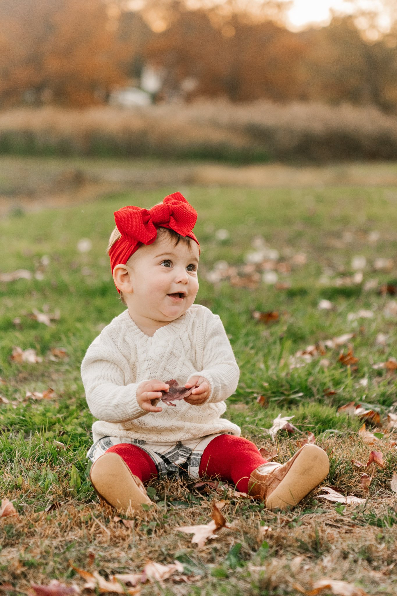  Candid toddler portrait with a little girl wearing white and red by Nicole Hawkins Photography. fall baby picture outfits #NicoleHawkinsPhotography #NicoleHawkinsFamily #fallfamilyphotos #fallphotos #familyphotographerNJ #NJfallfamilypics 