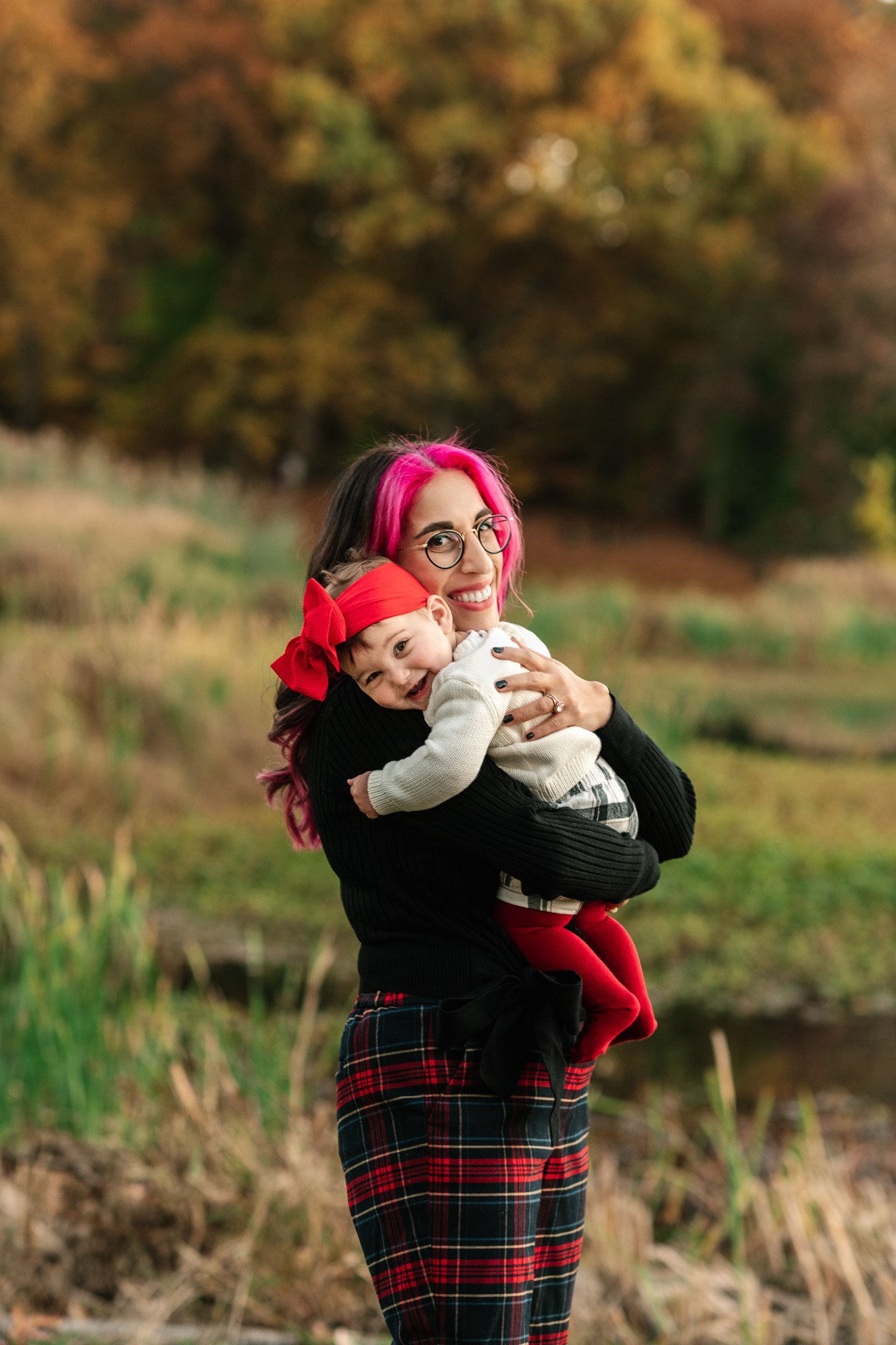  Nicole Hawkins Photography captures a baby girl hugging her mommy during fall family portraits in NJ. NJ fall portraits #NicoleHawkinsPhotography #NicoleHawkinsFamily #fallfamilyphotos #fallphotos #familyphotographerNJ #NJfallfamilypics 